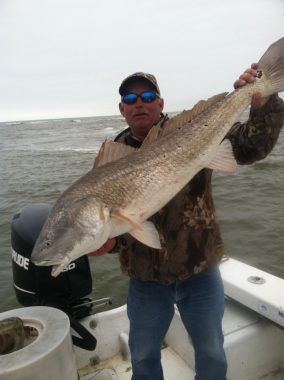 St. George Island Fishing Charters - Woodduck holding Red