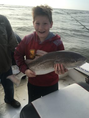 Fishing Guide in St George Island - Young boy excited about catching a redfish