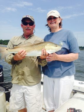 Apalachicola Fishing Guides - Woodduck and client holding huge redfish