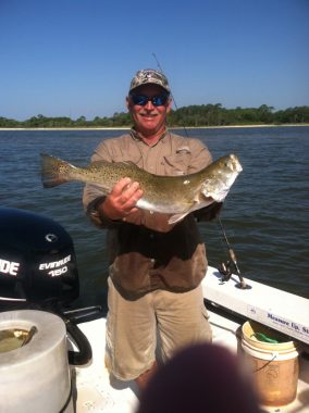 Fishing Charters in Apalachicola - Woodduck holding a Trout