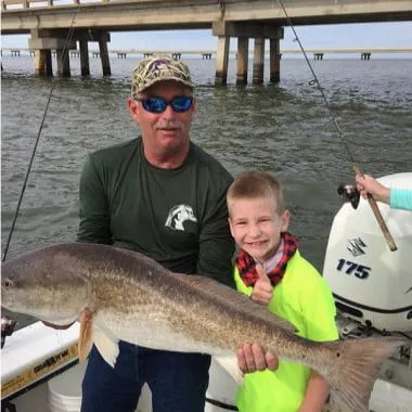 Woodduck-holding-a-huge-redfish-Fishing-in-Aplachicola-Bay